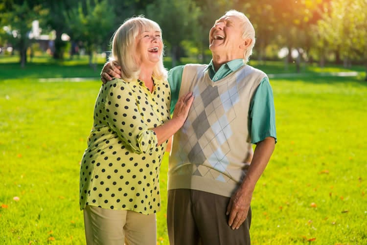 Image shows a couple laughing.