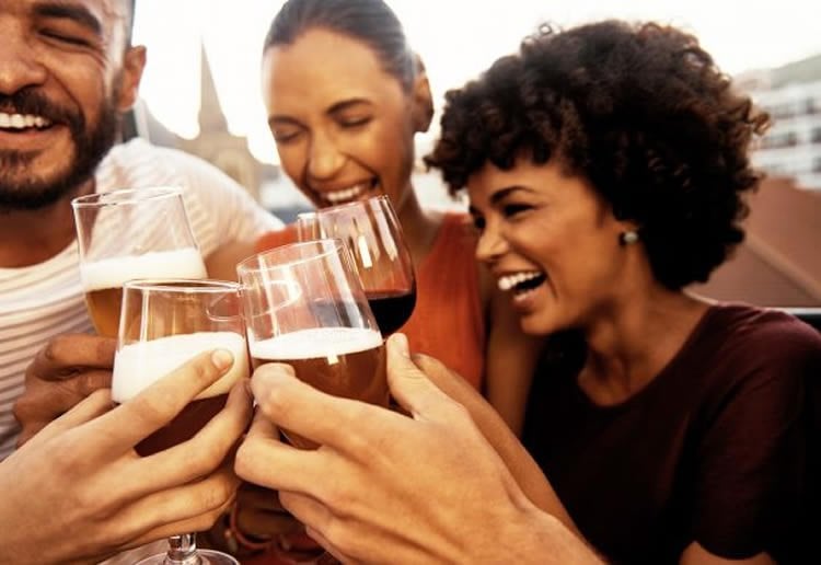 Image shows people drinking wine.