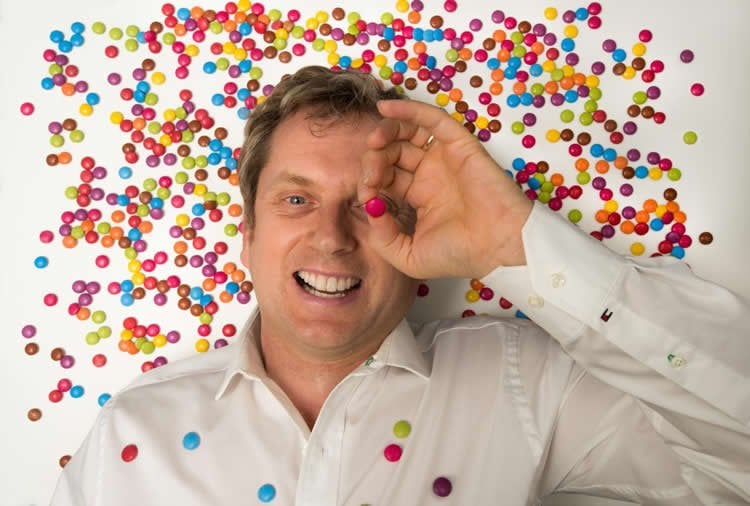 Image shows the researcher covered in Smarties.