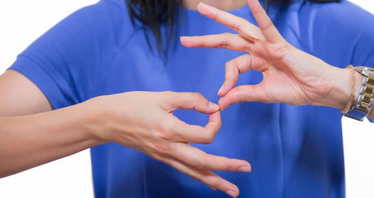 Image shows a person signing.