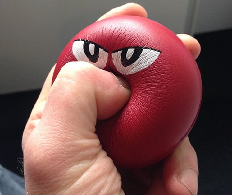 Image shows a person squeezing a stress ball.