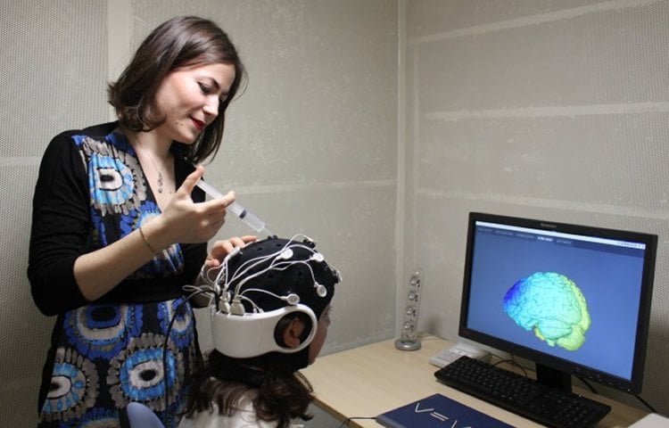 Image shows a researcher with a test subject.