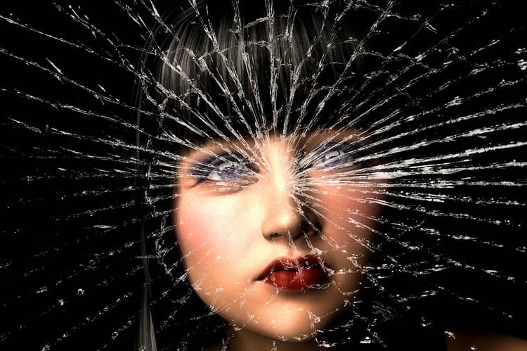 Image shows a woman and shattered glass.