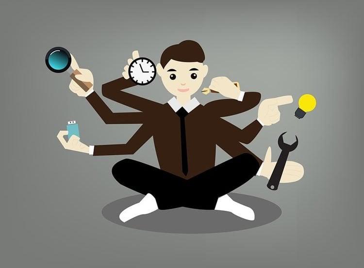 Image shows a cartoon of a person multitasking.