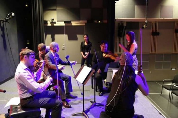 Image shows a group of musicians practicing.