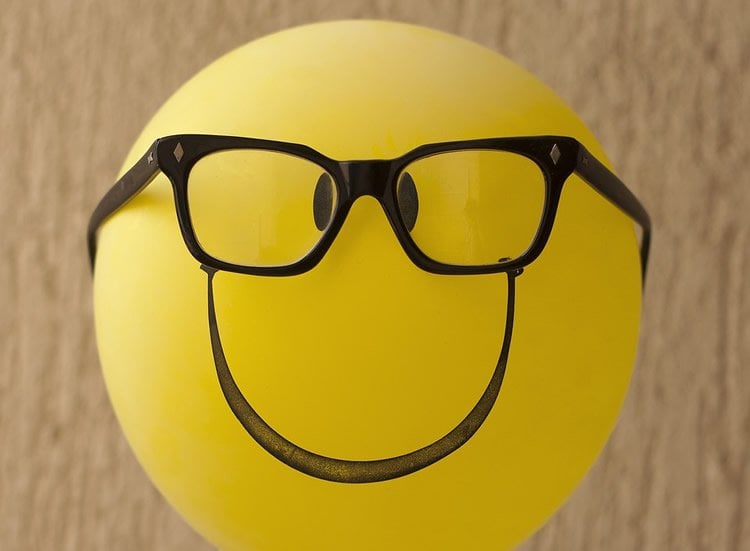 Image shows a ballon with glasses and a smiley face