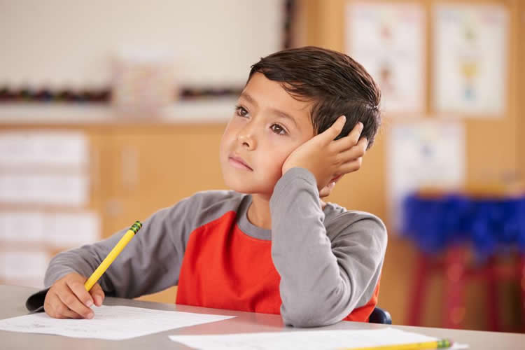 Image shows a young boy at school.