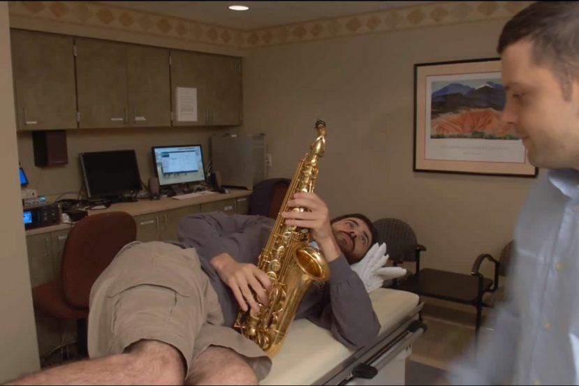 Image shows the patient with his saxophone.