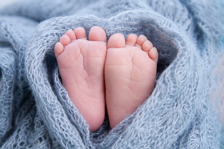 Image shows baby feet.
