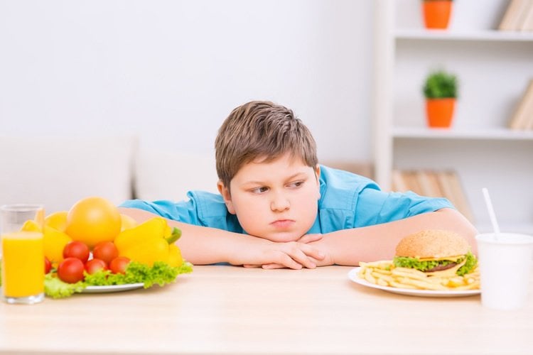 Image shows a boy and food.