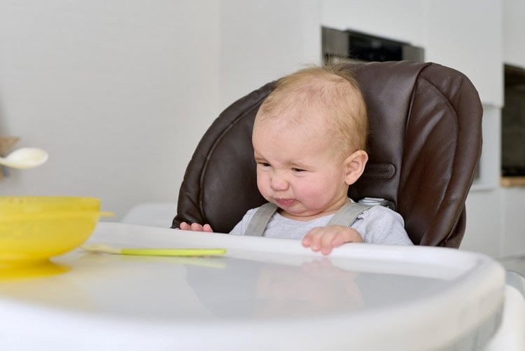 Image shows toddler at a table.