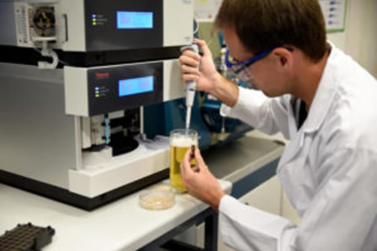 Image shows the researcher testing beer.
