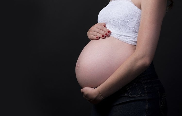 Image shows a pregnant woman.