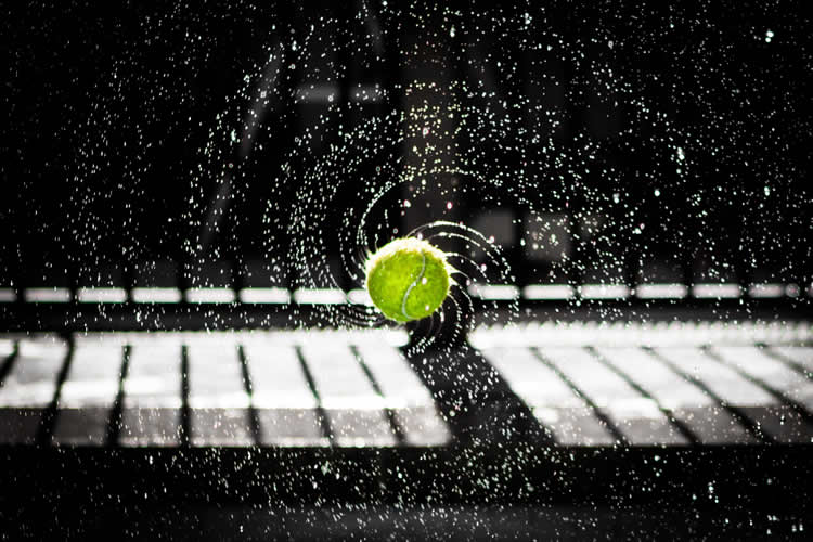 Image shows a tennis ball bouncing.