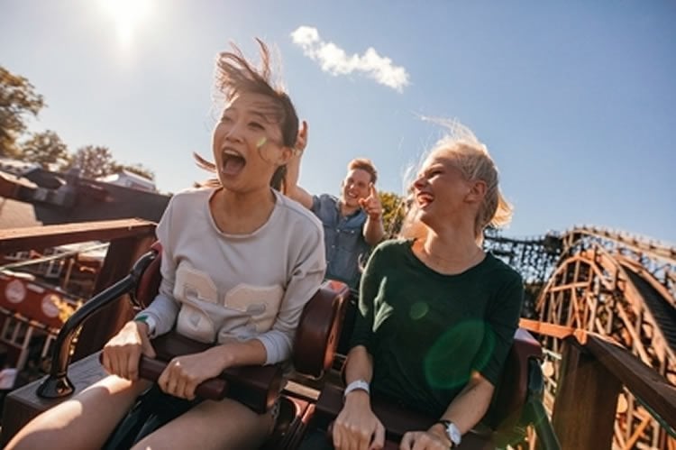 Image shows people on a rollercoaster.