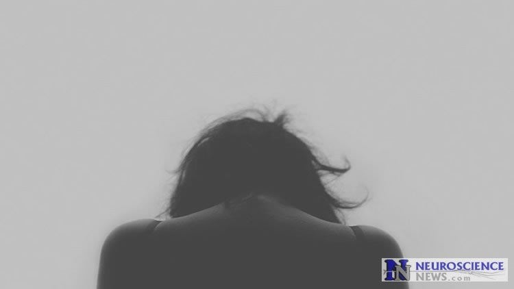 Image shows a depressed woman.