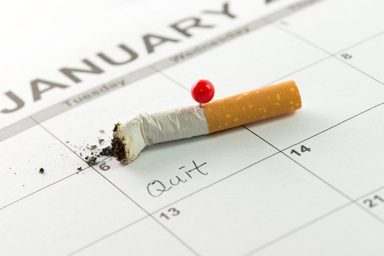 Image shows a stubbed out cigarette on a calendar.