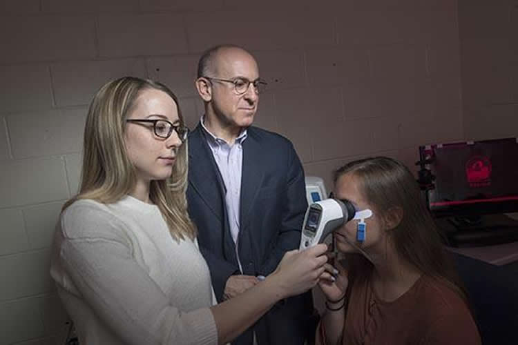 person performing an eye test