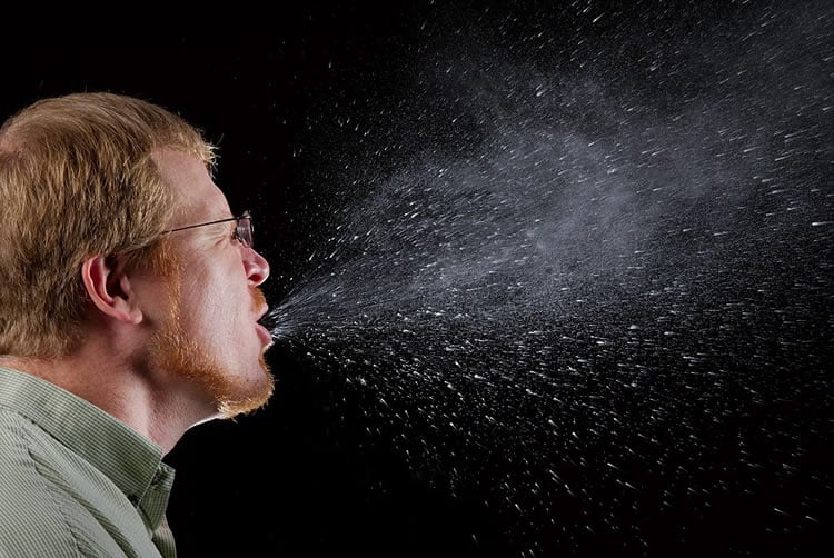  a man sneezing