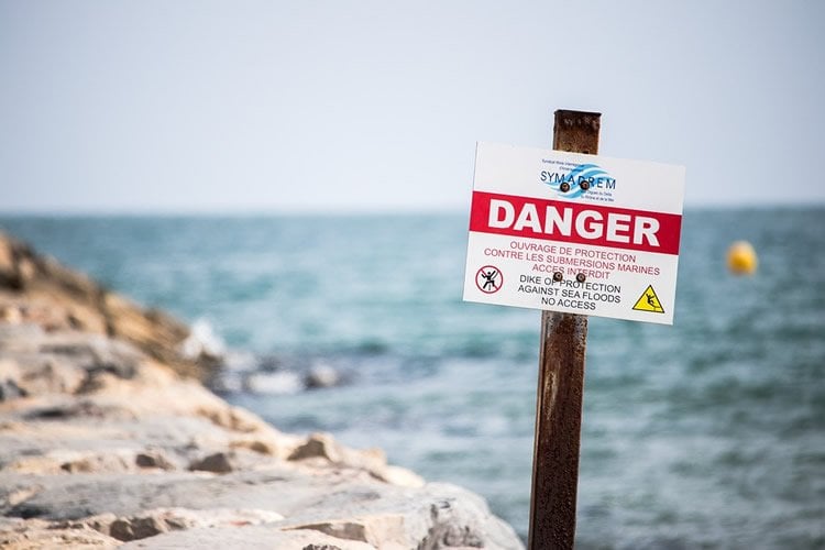 a danger sign on a beach