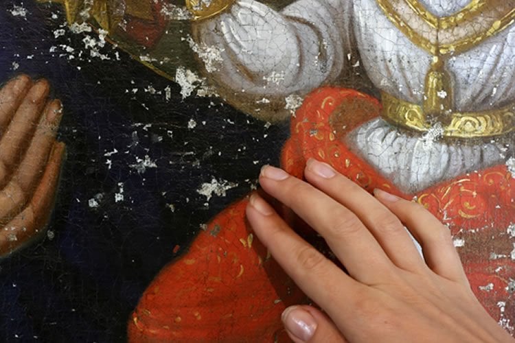 a person touching a painting