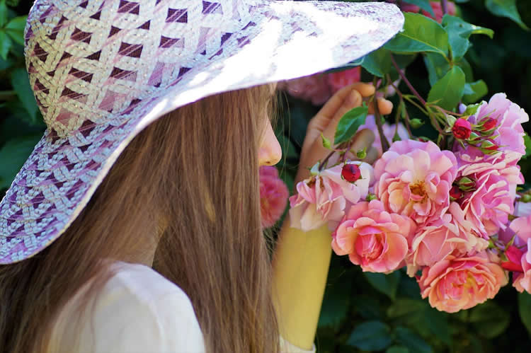 This shows a person smelling a flower