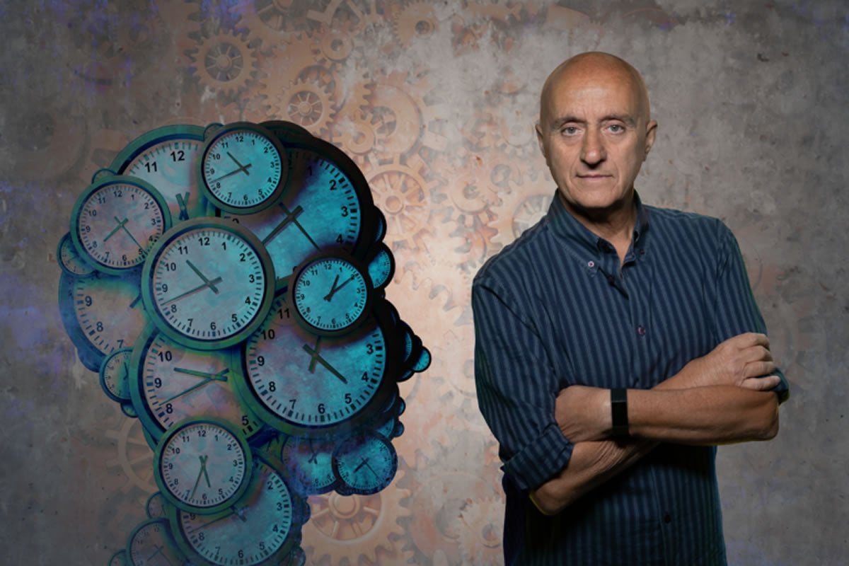 This shows the researcher next to a head made of clocks