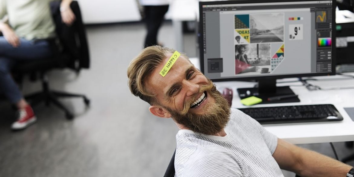 This shows a happy man in an office