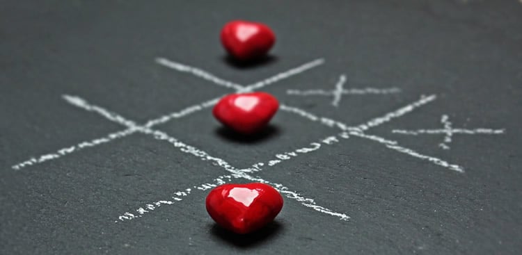 Hearts are shown as pieces on a tic-tac-toe board