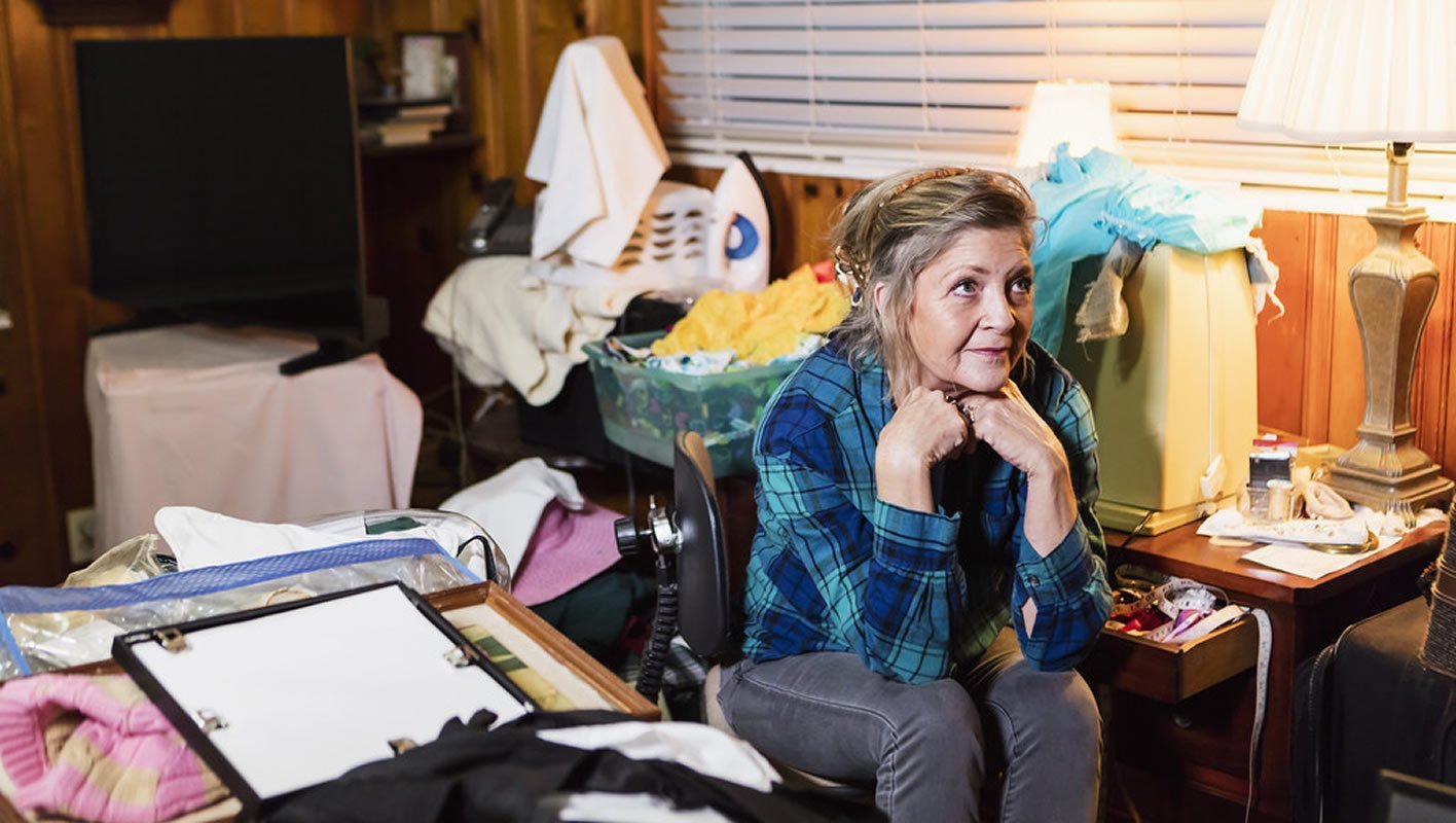 This shows a woman surrounded by clutter