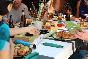 This shows people eating christmas lunch around a table