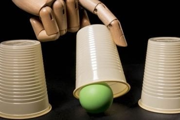 This shows a robotic hand playing the ball under the cup game