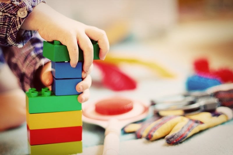 This shows a child building with blocks