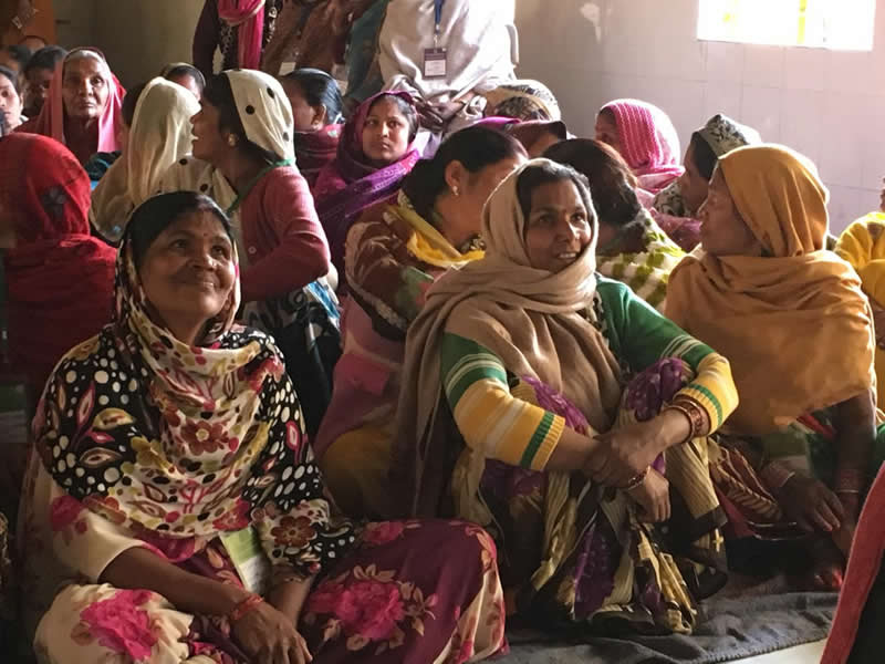 This shows a group of ladies in India learning to read