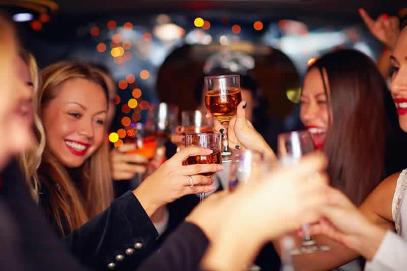 The image shows a group of women drinking at a party