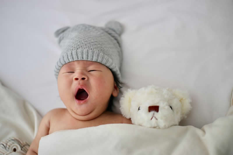 This shows a baby yawning