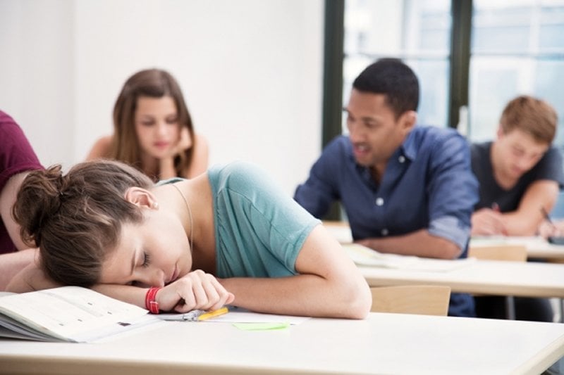 This shows a student sleeping at her desk