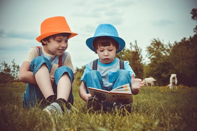 This shows two little boys reading