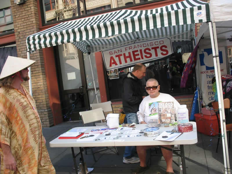 This shows a person at an atheist booth