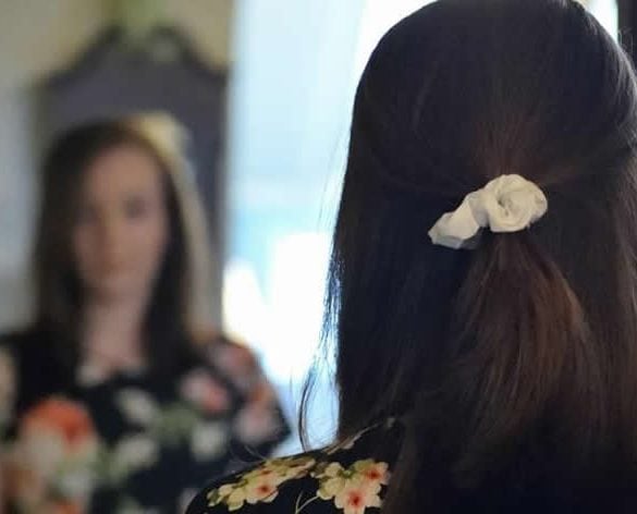 This shows a girl looking in a mirror