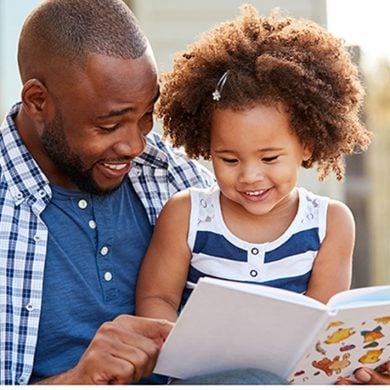 This shows a dad reading to his daughter