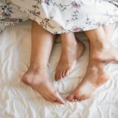 This shows a couple's feet sticking out of blankets