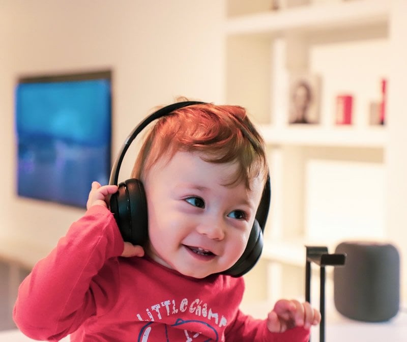 This shows a toddler in headphones
