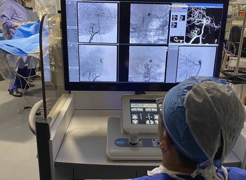 This shows a surgeon using the robotic system