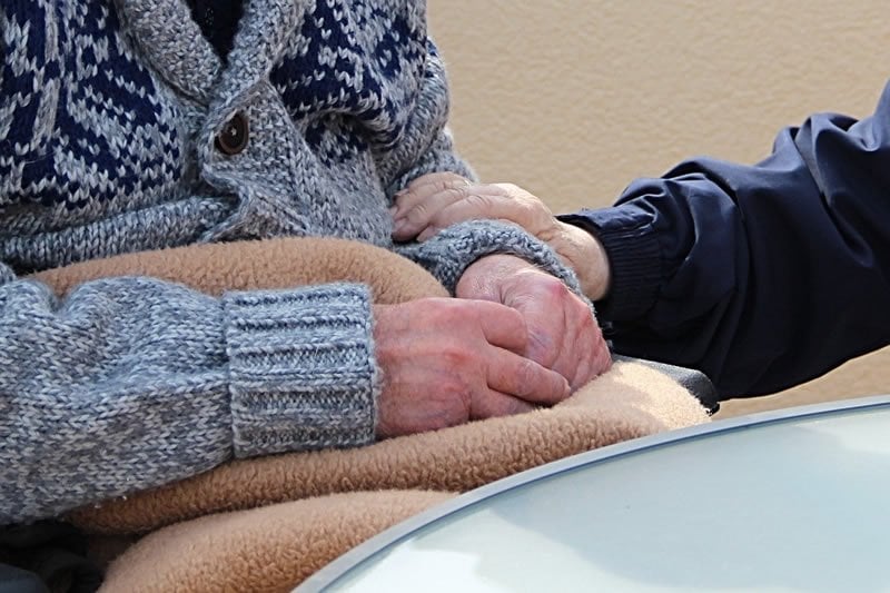 This shows an old person's hands