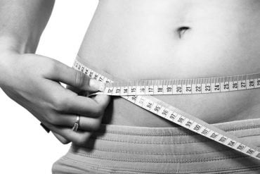 This shows a woman measuring her belly
