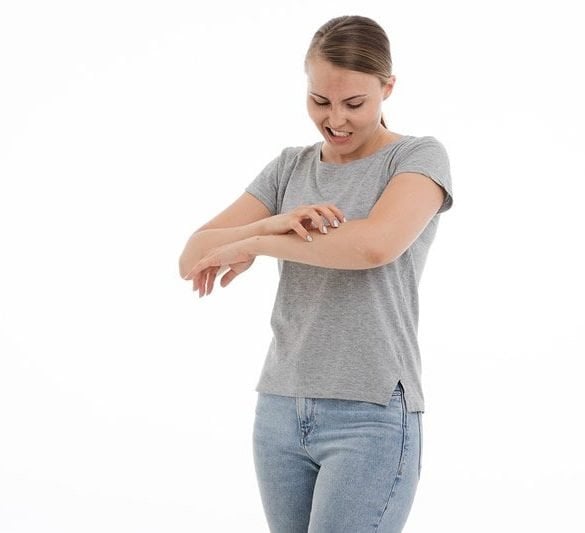 This shows a woman scratching