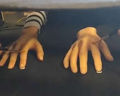 This shows the rubber hand illusion experiment being performed