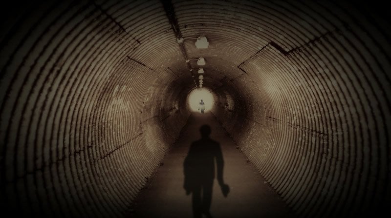 This shows the shadow of a man in a tunnel