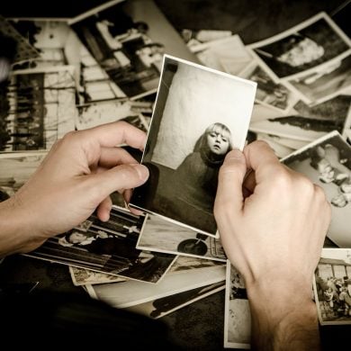 This shows a man looking at old photos